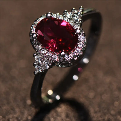 Anello in Argento con Rubino e Cornice Halo